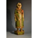 A 19th century Indian softwood figure, of a lady, she stands, dressed in a sari,