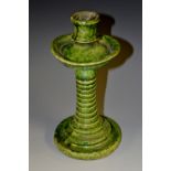 A 19th century green ware candlestick, campagna sconce, broad dished drip pan,