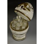 A 19th century glass 'medicine egg', hinged cover enclosing a bottle and six tots,