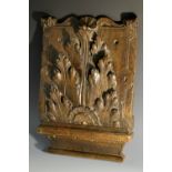 A 17th century oak architectural fragment, carved with acanthus, shell cresting, strapwork border,