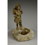 A 19th century bronzed figure, of a Highland soldier, he stands, in traditional uniform,