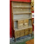 An unusual late Victorian kitchen dresser, waterfall shelving and three long drawers to top,