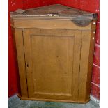 A Victorian painted pine wall mounted corner cupboard, ogee cornice, canted angles, panel door.