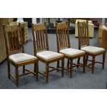 A set of four oak Arts and Crafts lath back dining chairs, carved top rail, drop in seats,