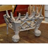 A George III Gothic revival fire grate on ball and claw feet