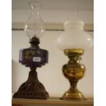 A Victorian cast iron and painted paraffin lamp, purple painted reservoir, etched floral chimney,