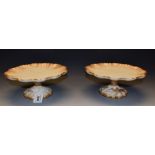 A pair of Doulton Burslem comports, wavy tops, bird and foliate columns and feet,