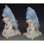 A pair of Continental porcelain cherubs and shoes,