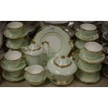 A Paragon tea service for twelve (missing one cup), pale green with gilded edging pattern 3849,