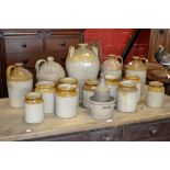 A stoneware slip glazed flagon with handle; others including two tone flagons, preserve jars,