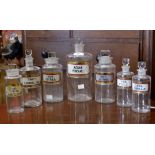 Apothecary jars, gilt labels, assorted sizes.