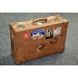 A brown leather suitcase, with Cunard Line, White star paper labels,