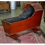 A Victorian stained pine cradle on stand.