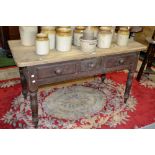 A Victorian pine kitchen table, three short drawers to frieze, turned legs, circa 1880.