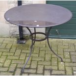 A circular steel garden table