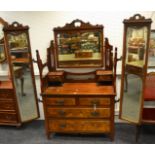 An early 20th century mahogany and burr walnut dressing chest, flanked by tall foldable mirrors c.