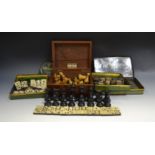 A set of bone and ebony dominoes pieces; wooden draughts and chess pieces;