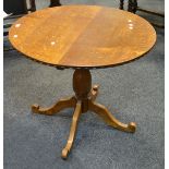 A mid 20th century oak circular side table,