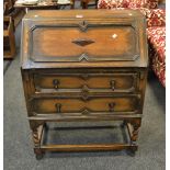 An early 20th century fall front bureau, the front enclosing pigeon holes, barley twist supports, c.