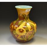 A George Jones-style shaped baluster vase, painted with stylised Hibiscus flowers,