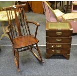 A 20th Century stained ash rocking chair; a contemporary chest of four long drawers;