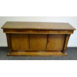 A German Biedermier style mahogany sideboard, three short drawers to frieze,