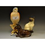 Beswick - a Beswick bisque model of a kestrel; a Beswick model of a seated Siamese cat;