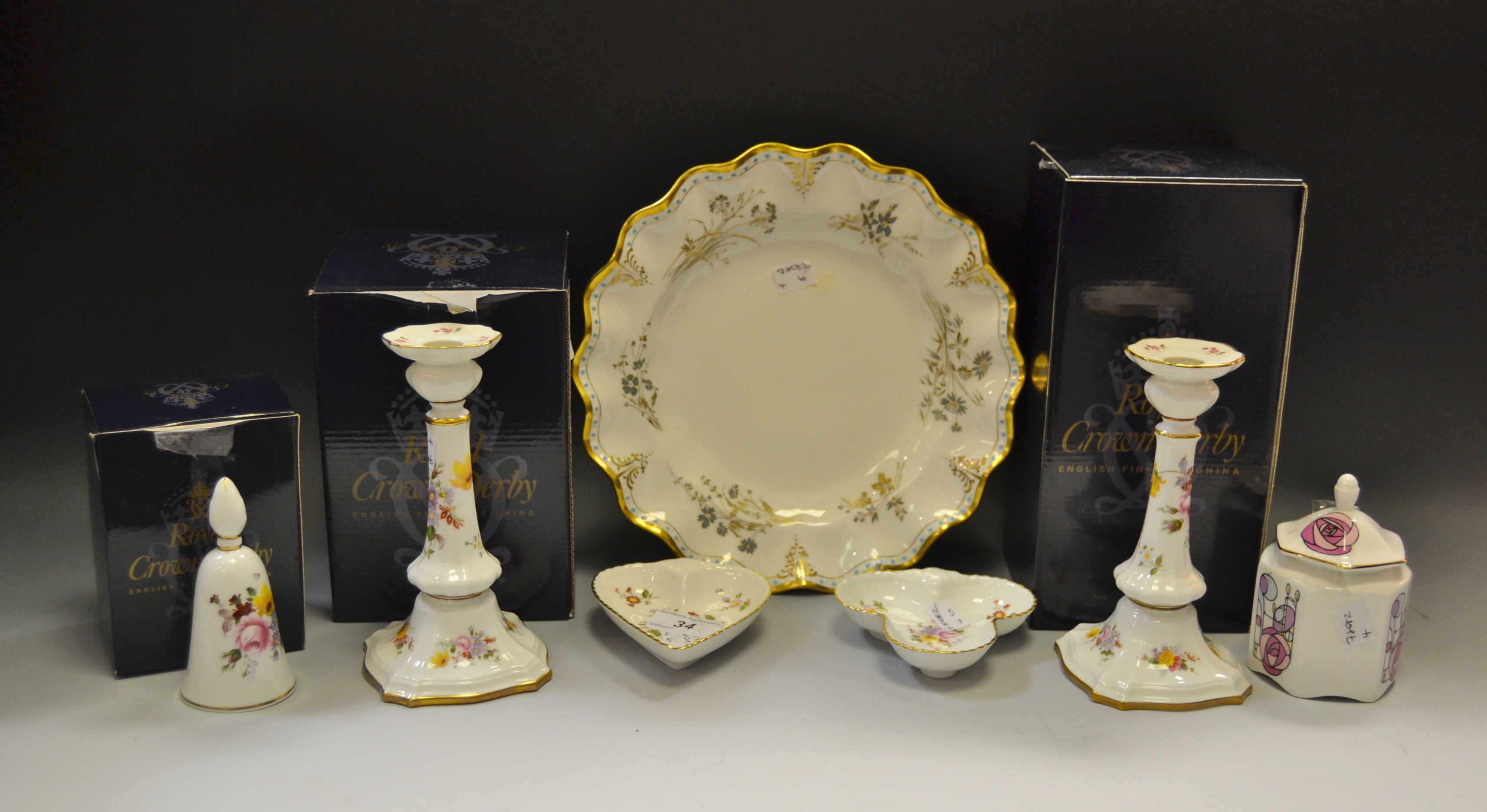 A pair of Royal Crown Derby Posies pattern candlesticks; a similar bell; trinket dishes;