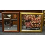 A contemporary gilt framed mirror with bevelled glass; another,