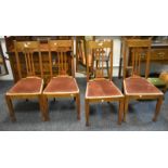 A set of four oak Art Nouveau style dining chairs, pierced splats, drop in seats, c.