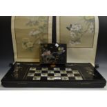 A Chinese ebonised gaming board, inlaid in abalone, 64cm wide; a similar jewellery box,