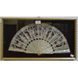 A 19th century French mother-of-pearl and lace fan, sixteen sticks and guards pierced 45cm wide,