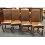 A set of four high back leather chairs,