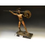 A brass figure of a Spartan warrior throwing a spear