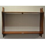 A stained pine wall hanging shelf unit