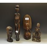 An African hardwood figure of a Tribal Woman carrying a water pot;
