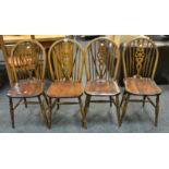 A set of four mid 20th century wheel back dining chairs