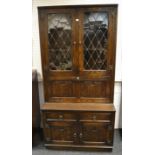 An Old Charm-style oak bureau bookcase, astral glazed cupboard doors enclosing two shelves,