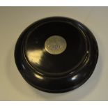 A Victorian ebonised circular snuff box, the cover set with a silver coloured metal roundel, c.