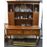 A mid-20th century oak dresser, ogee cornice over shaped frieze,