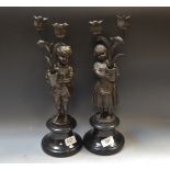Becquerel, after, a pair, bronze figural candlesticks, of two children standing bare footed,