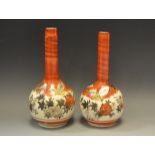 A pair of Kutani painted onion vases, decorated with traditional flowers and insects,