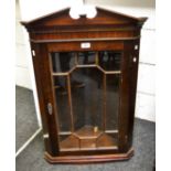 An early 20th century wall mounted, mahogany, astral glazed , splay fronted,
