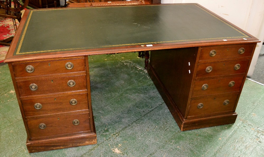 A reproduction mahogany partner's desk, leather inlaid top, four graduated drawers to each pedestal,