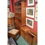 A retro teak telephone seat; a tile top teak nest of three tables; a modern pine bookcase cabinet,