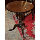 A George III mahogany tilt-top table, circular top, canon barrel column, tripod base.