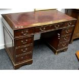 A reproduction mahogany twin pedestal desk, leather inlaid top, an arrangement of nine drawers.