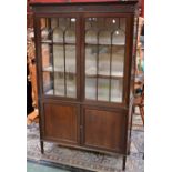 An Edwardian mahogany display cabinet, stepped cornice, fluted frieze,