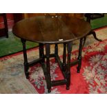 An 18th century oak dropleaf table, oval top, associated 19th century base,