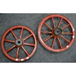 A vintage metal bound ten spoked barrow wheel, approx 46cm diameter; another smaller, eight spoked,